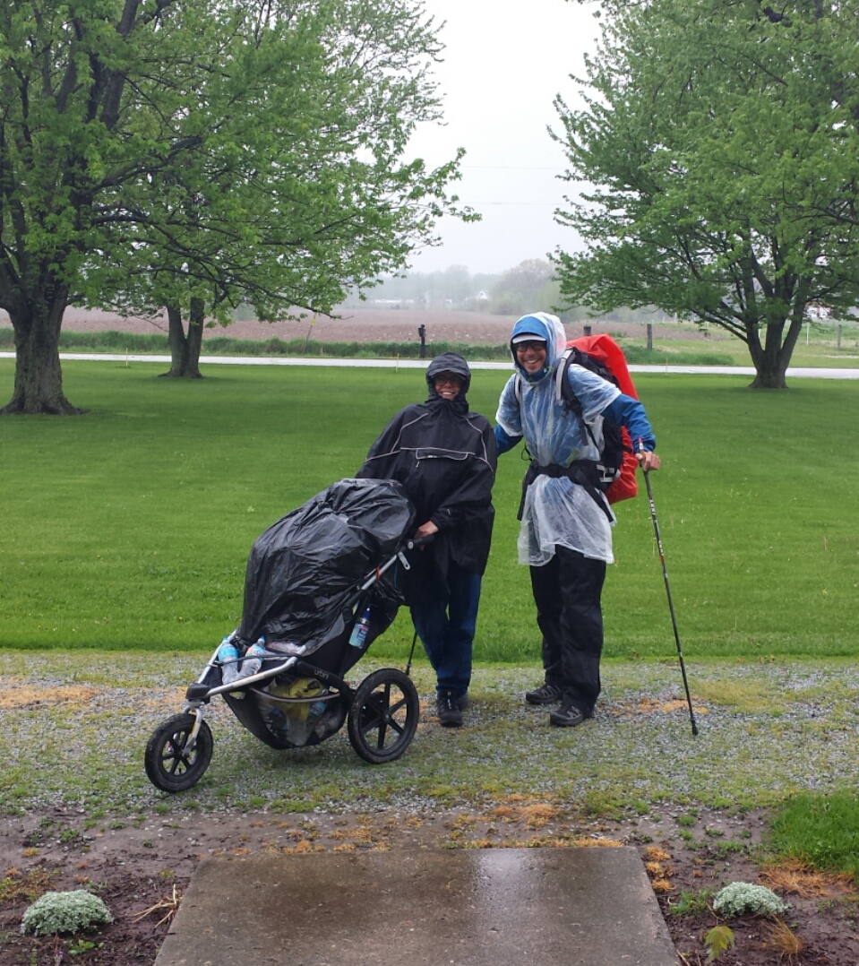 Martin and Beatrice on the Nickel Plate Trail with their stroller in the rain